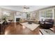 Inviting living room with a fireplace, plush seating, and natural light from large windows at 1204 Caribou Xing, Durham, NC 27713