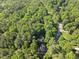Aerial view of homes in a neighborhood with a paved road at 128 Cobblestone Dr, Chapel Hill, NC 27516