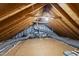Large attic with exposed beams, plywood flooring, insulation, and HVAC system at 128 Cobblestone Dr, Chapel Hill, NC 27516