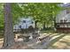 Backyard with fire pit area, seating and wooded views at 128 Cobblestone Dr, Chapel Hill, NC 27516
