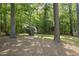 Scenic backyard featuring mature trees and lush greenery at 128 Cobblestone Dr, Chapel Hill, NC 27516