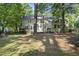 View of the back of the home showing the large deck, and multiple windows at 128 Cobblestone Dr, Chapel Hill, NC 27516