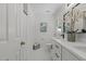 Bathroom featuring dual sinks, white cabinets, a large mirror, and tiled floors at 128 Cobblestone Dr, Chapel Hill, NC 27516