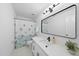 Bright bathroom featuring a single sink vanity, white tiling, and modern hardware at 128 Cobblestone Dr, Chapel Hill, NC 27516