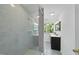 Bathroom showcasing a glass shower, vanity, mirror and a large window for natural light at 128 Cobblestone Dr, Chapel Hill, NC 27516