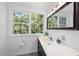 Bathroom featuring a vanity, mirror, and window providing natural light and a refreshing view at 128 Cobblestone Dr, Chapel Hill, NC 27516