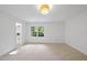 Bright bedroom featuring neutral carpet, white walls, and natural light at 128 Cobblestone Dr, Chapel Hill, NC 27516