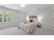 Bright bedroom with neutral decor, soft carpet, and a light-filled window view at 128 Cobblestone Dr, Chapel Hill, NC 27516