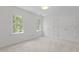 Light-filled bedroom features soft carpet, and two bright windows with leafy views at 128 Cobblestone Dr, Chapel Hill, NC 27516