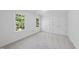 Neutral bedroom featuring two windows, carpet, and double closets at 128 Cobblestone Dr, Chapel Hill, NC 27516