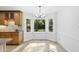 Bright breakfast nook with large windows overlooking a lush backyard at 128 Cobblestone Dr, Chapel Hill, NC 27516