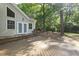 Wood deck with access to backyard area surrounded by a lush green forest at 128 Cobblestone Dr, Chapel Hill, NC 27516
