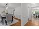 View of the formal dining room showcasing the chandelier, furniture, and entryway at 128 Cobblestone Dr, Chapel Hill, NC 27516