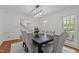 Elegant dining room with hardwood floors, decorative chandelier, and a table with upholstered chairs at 128 Cobblestone Dr, Chapel Hill, NC 27516