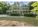 Charming two-story home with a welcoming front porch, lush landscaping, and classic architectural details at 128 Cobblestone Dr, Chapel Hill, NC 27516