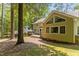 Back exterior view of a home featuring a spacious deck and large windows at 128 Cobblestone Dr, Chapel Hill, NC 27516