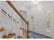 Bright foyer featuring hardwood floors, white trim, and a staircase with wood railing and white risers at 128 Cobblestone Dr, Chapel Hill, NC 27516