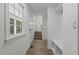 Hallway with neutral tile, leading to carpeted stairs with convenient coat hooks and bench at 128 Cobblestone Dr, Chapel Hill, NC 27516