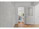 Bright hallway featuring tile flooring, white doors, and a glimpse into the dining room at 128 Cobblestone Dr, Chapel Hill, NC 27516