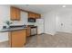 Charming kitchen featuring wood cabinets, sleek appliances, and durable tile flooring at 128 Cobblestone Dr, Chapel Hill, NC 27516