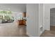 Open concept kitchen with wooden cabinets and breakfast bar seamlessly connects to the living area at 128 Cobblestone Dr, Chapel Hill, NC 27516