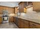 Kitchen featuring stainless appliances, tile backsplash, granite countertops and ample cabinetry at 128 Cobblestone Dr, Chapel Hill, NC 27516