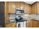 Close up of a kitchen range, showing stainless steel appliances and countertop at 128 Cobblestone Dr, Chapel Hill, NC 27516
