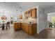 Spacious kitchen with wooden cabinets, granite countertops, tile backsplash, and an adjacent dining area at 128 Cobblestone Dr, Chapel Hill, NC 27516
