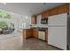Kitchen area boasting wood cabinets, stainless appliances, and granite countertops with natural light at 128 Cobblestone Dr, Chapel Hill, NC 27516