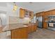 Open kitchen featuring granite countertops, tile backsplash, stainless steel appliances and wooden cabinetry at 128 Cobblestone Dr, Chapel Hill, NC 27516
