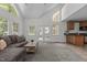 Bright living room with vaulted ceiling, large windows, and open access to a cozy kitchen area at 128 Cobblestone Dr, Chapel Hill, NC 27516