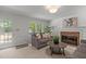 Bright living room features a fireplace, neutral paint, plush seating, and a glass panel door at 128 Cobblestone Dr, Chapel Hill, NC 27516