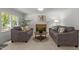 Bright living room features a fireplace, neutral paint, plush seating, and a large window at 128 Cobblestone Dr, Chapel Hill, NC 27516