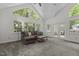 Spacious living room with a vaulted ceiling, large windows and a comfortable sectional sofa at 128 Cobblestone Dr, Chapel Hill, NC 27516