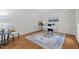 Bright home office with hardwood floors, a modern white desk, and a stylish accent rug at 128 Cobblestone Dr, Chapel Hill, NC 27516
