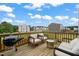 Relaxing back deck with outdoor seating, a grill, and views of the surrounding neighborhood at 138 Boarstall Crk, Durham, NC 27707