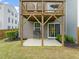 Backyard features a patio, a grassy area, a view of the upper deck, and a sliding glass door at 138 Boarstall Crk, Durham, NC 27707