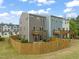 Backyard features a wooden fence, grass, a patio, and a deck with outdoor furniture at 138 Boarstall Crk, Durham, NC 27707