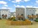 Fenced backyard with a small seating area, a lawn, and views of the neighborhood's exterior and decks at 138 Boarstall Crk, Durham, NC 27707