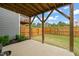 Backyard features a patio, grassy area, wooden fence, and a view of the upper deck at 138 Boarstall Crk, Durham, NC 27707
