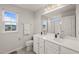 Bright bathroom with dual sinks, a large mirror, and a shower with glass doors at 138 Boarstall Crk, Durham, NC 27707