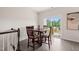 Cozy dining area featuring a wooden table, four chairs, and a sliding glass door to the outside deck at 138 Boarstall Crk, Durham, NC 27707