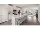 Open concept kitchen features white cabinets, stainless steel appliances, quartz countertops, and island seating at 138 Boarstall Crk, Durham, NC 27707