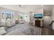 Bright and inviting living room with a TV, comfortable seating, large windows, and an elegant blue patterned rug at 138 Boarstall Crk, Durham, NC 27707