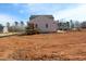 New two-story home with board and batten siding and a wooden deck overlooking the backyard at 1403 Reading Ct # 75 Kl, Burlington, NC 27217