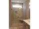 A light-filled walk-in shower features a glass door, a built-in bench, and tiled walls at 1403 Reading Ct # 75 Kl, Burlington, NC 27217