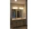 Dual sink vanity in bathroom with white countertop, large mirror, and ample storage at 1403 Reading Ct # 75 Kl, Burlington, NC 27217