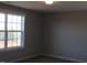 This cozy bedroom has plush carpet flooring and a large window that provides natural light and lovely views at 1403 Reading Ct # 75 Kl, Burlington, NC 27217