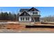 New two-story home with board and batten siding and a brick foundation on a construction lot at 1403 Reading Ct # 75 Kl, Burlington, NC 27217