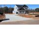 New two-story home with board and batten siding and a concrete driveway on a construction lot at 1403 Reading Ct # 75 Kl, Burlington, NC 27217